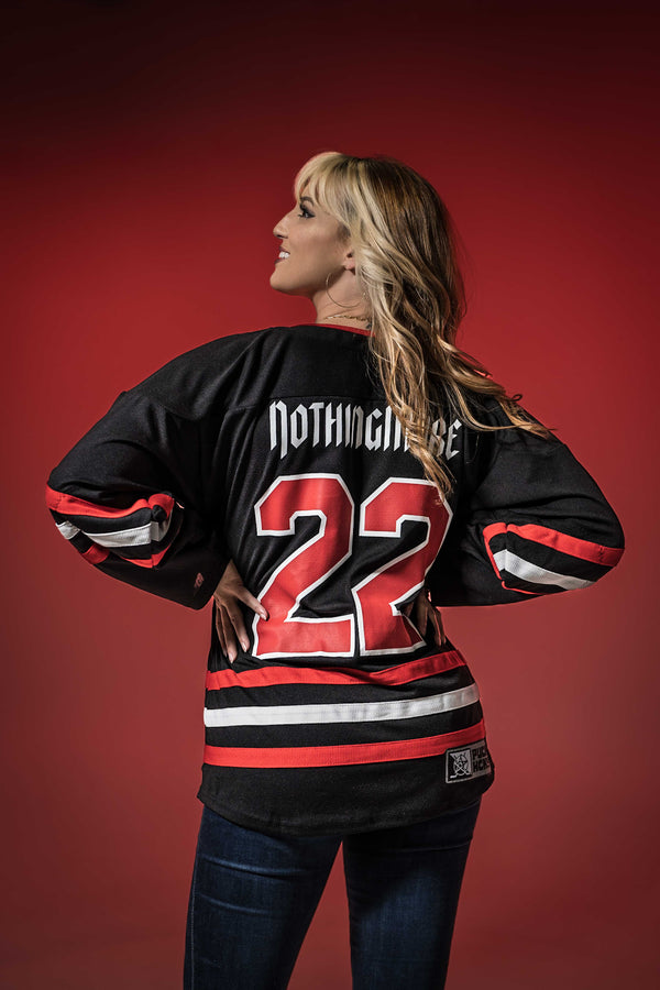 NOTHING MORE 'VALHALLA' deluxe hockey jersey in black, red, and white back view on female model