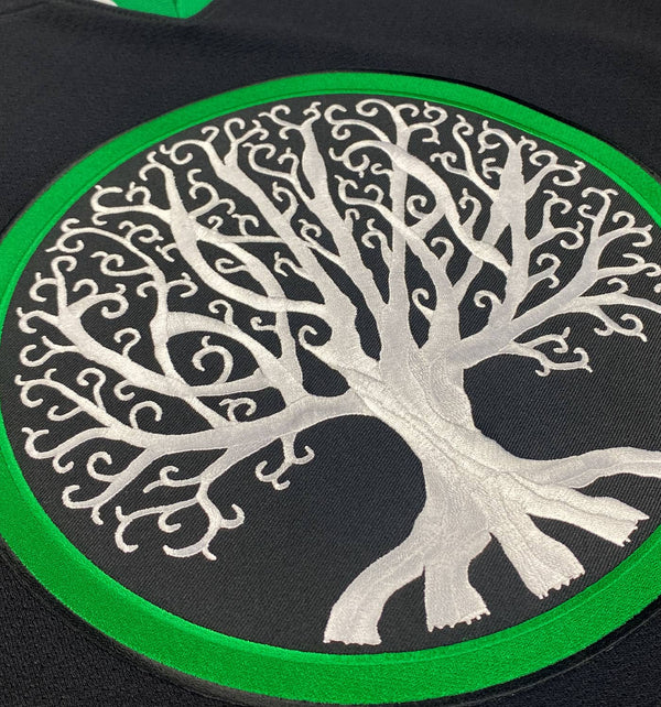 GOJIRA 'FROM THE TREES' deluxe hockey jersey in black, kelly green, and white close up