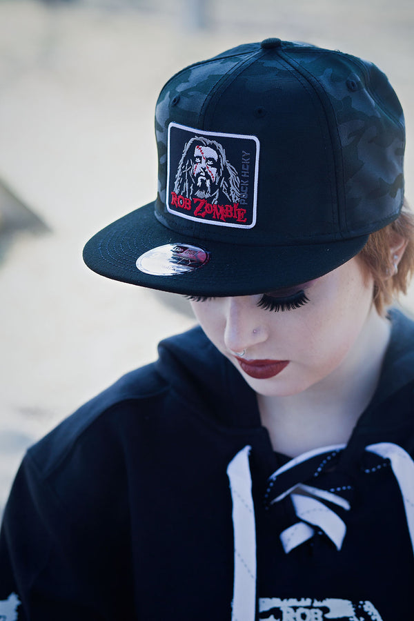 ROB ZOMBIE 'THUNDER FISTS 65' snapback hockey cap in black camo front view on model