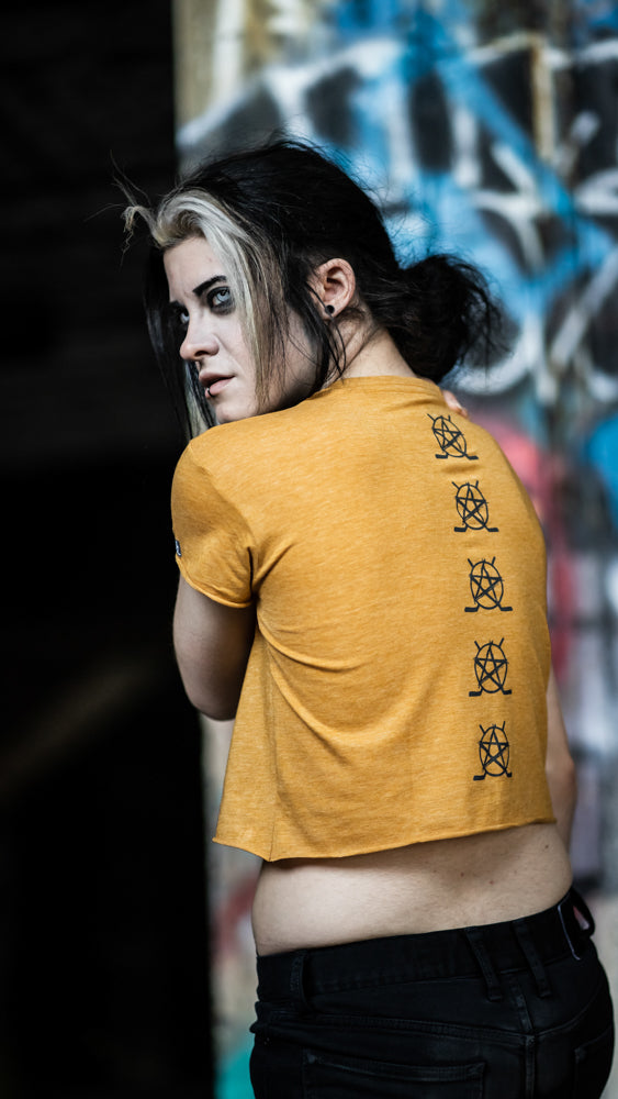 PUCK HCKY 'BOX' women's hockey crop top in gold back view on model