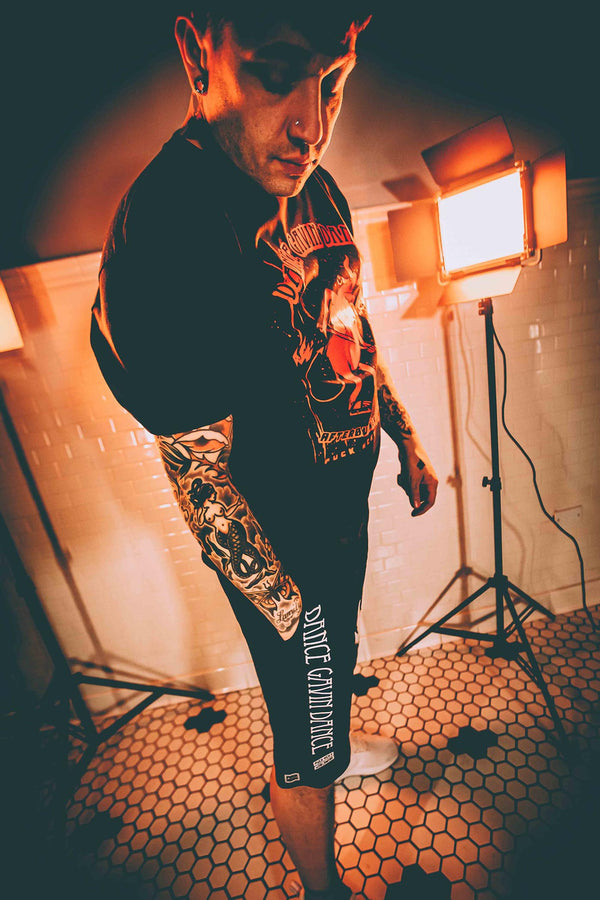 DANCE GAVIN DANCE 'MIDNIGHT CRUSADE' fleece hockey shorts in black on model