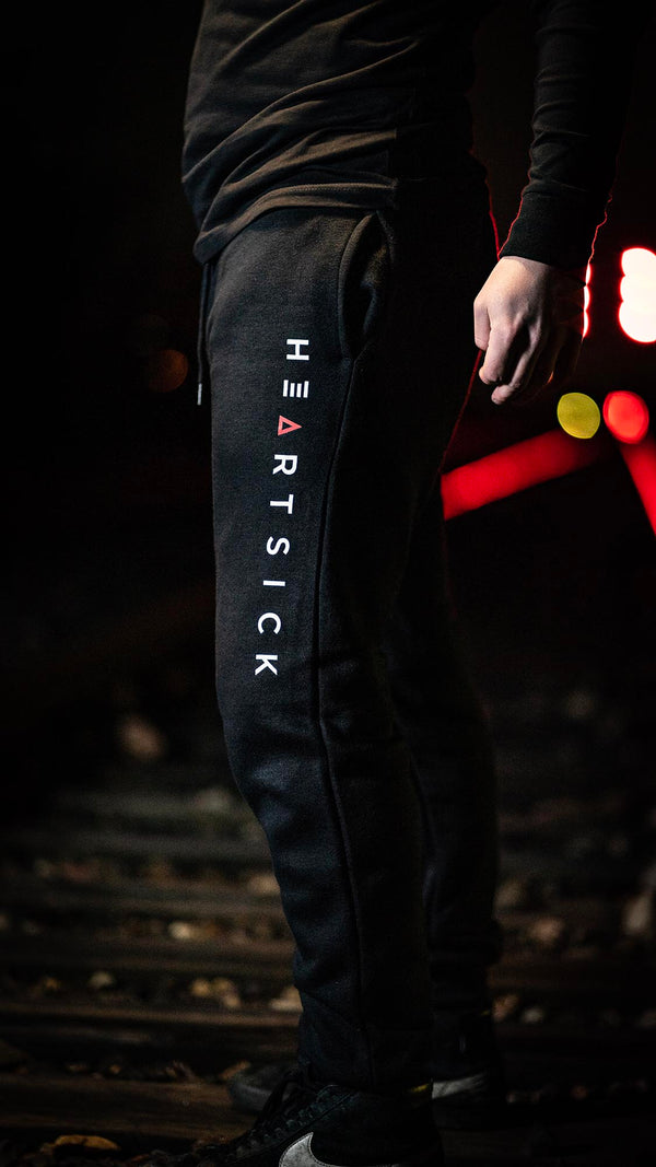 HEARTSICK ‘LOVELETTER’ hockey jogging pants in black on model