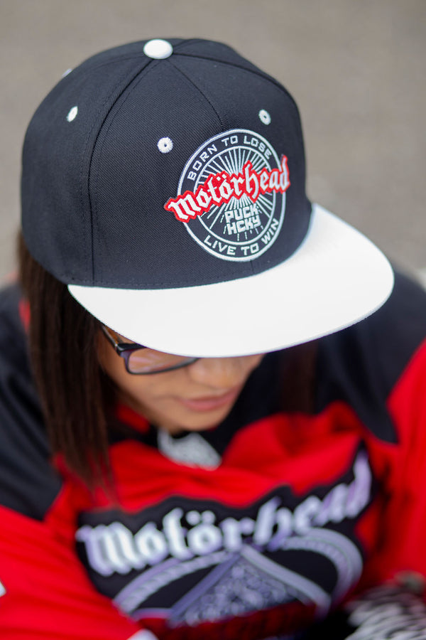 Motorhead 'OFFICIAL PUCK' flat bill snapback hockey cap in black with a white bill on model