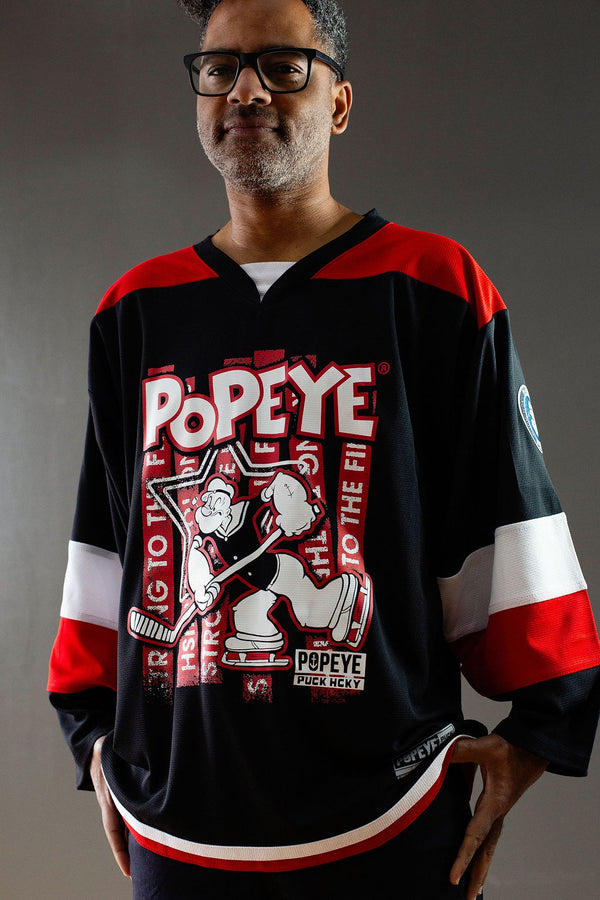 POPEYE 'STRONG TO THE FINISH' hockey jersey in black, red, and white front view on model