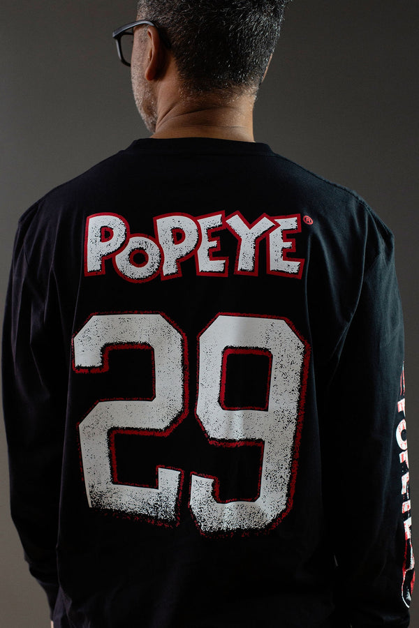 POPEYE 'STRONG TO THE FINISH' long sleeve hockey t-shirt in black back view on model