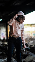 PUCK HCKY 'EQUIPMENT HAZMAT' women's cropped hockey hoodie in blush front view on model