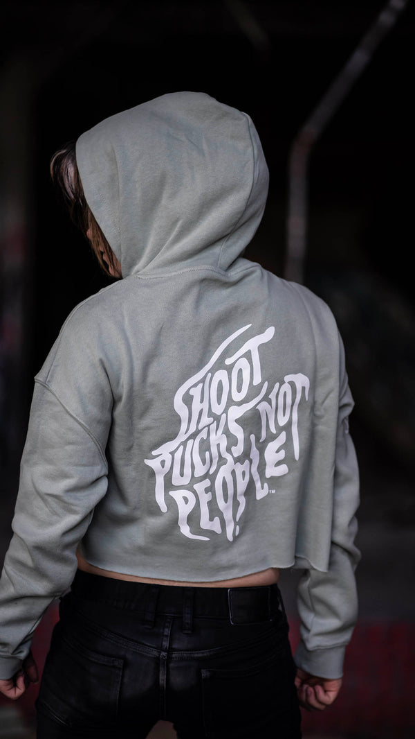 PUCK HCKY 'SHOOT PUCKS NOT PEOPLE - DRIPPY SCRIPT' women's cropped hockey hoodie in sage back view on model