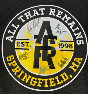 All That Remains 'Puckfire' hockey jersey in black, gold, and white AUTOGRAPHED crest close up