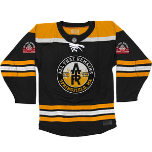 All That Remains 'Puckfire' hockey jersey in black, gold, and white front view