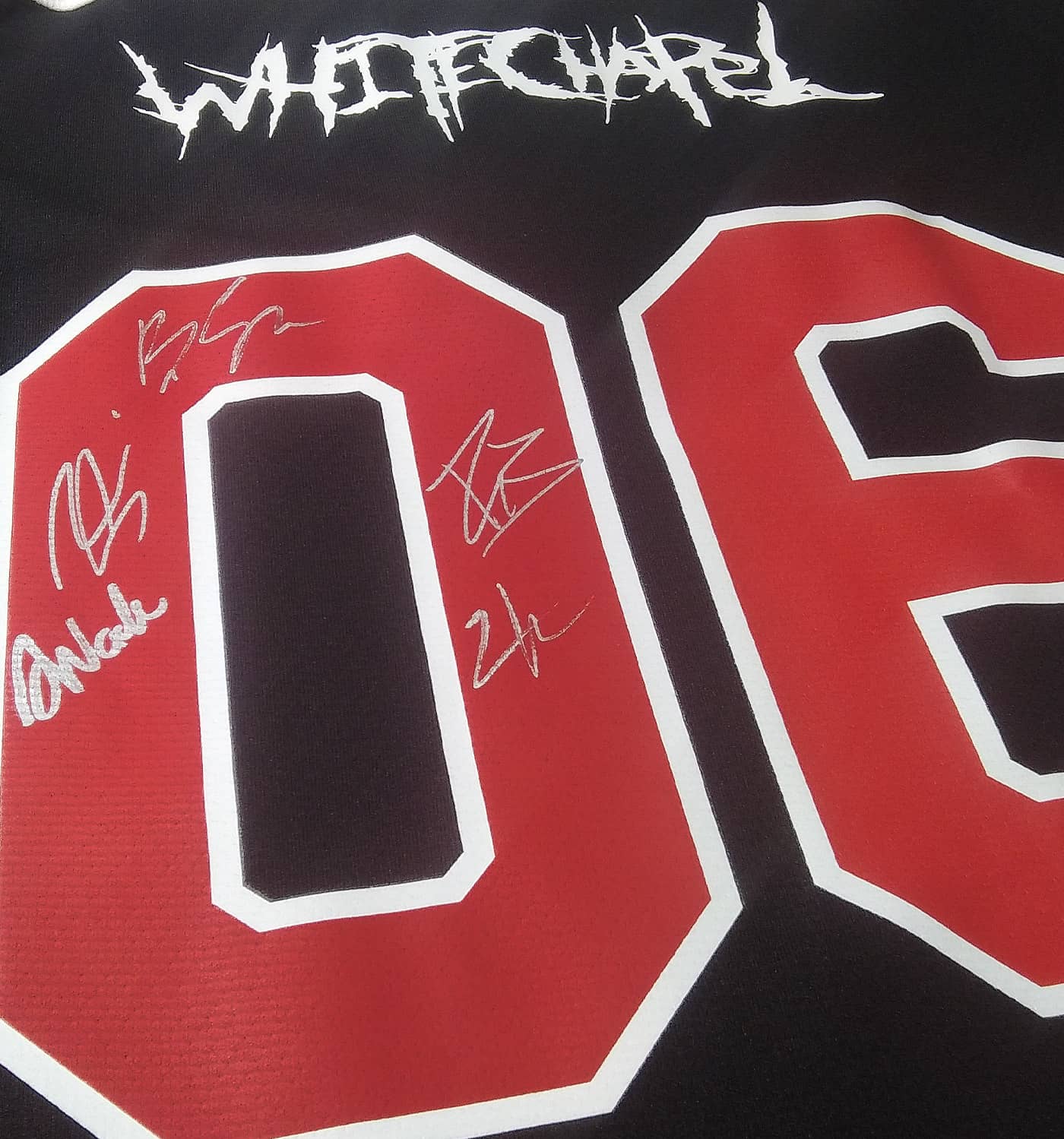 WHITECHAPEL 'REPROGRAMMED TO SKATE' deluxe limited edition autographed hockey jersey in black, red, and white back view