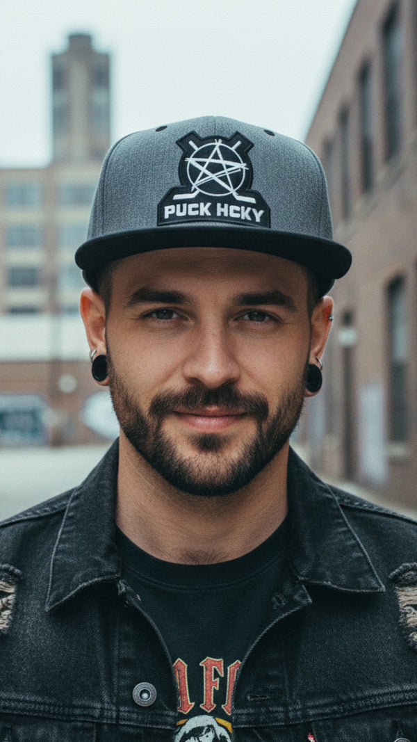 PUCK HCKY 'BIG STAR' flat bill snapback hockey cap in dark heather with black brim front view on model