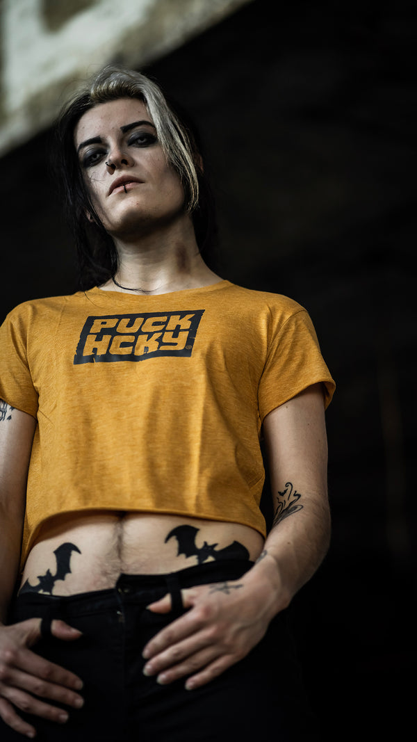 PUCK HCKY 'BOX' women's hockey crop top in gold front view on model