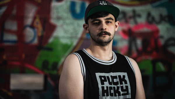 PUCK HCKY 'DETROIT' sleeveless summer league jersey in black, grey, and white front view on model