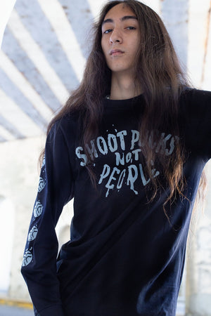PUCK HCKY 'Shoot Pucks Not People - Eagle Worldwide' long sleeve hockey t-shirt in black front view on model