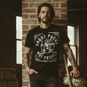 PUCK HCKY 'SHOOT PUCKS NOT PEOPLE - THE BIG SKATE' short sleeve hockey t-shirt in solid black on model front view