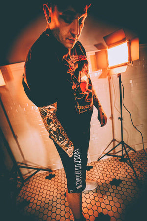DANCE GAVIN DANCE 'MIDNIGHT CRUSADE' fleece hockey shorts in black on model