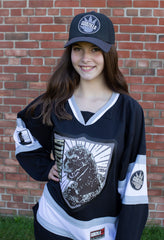 GODZILLA 'THE ORIGINAL G' deluxe youth hockey jersey in black, white, and grey front view on model