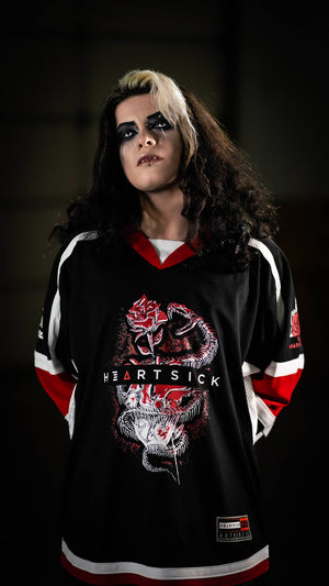 HEARTSICK 'THE SNAKE AND THE ROSE' hockey jersey in black, white, and red front view on model