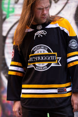 MESHUGGAH 'KNÖVELMETAL' hockey jersey in black, gold, and white front view on model