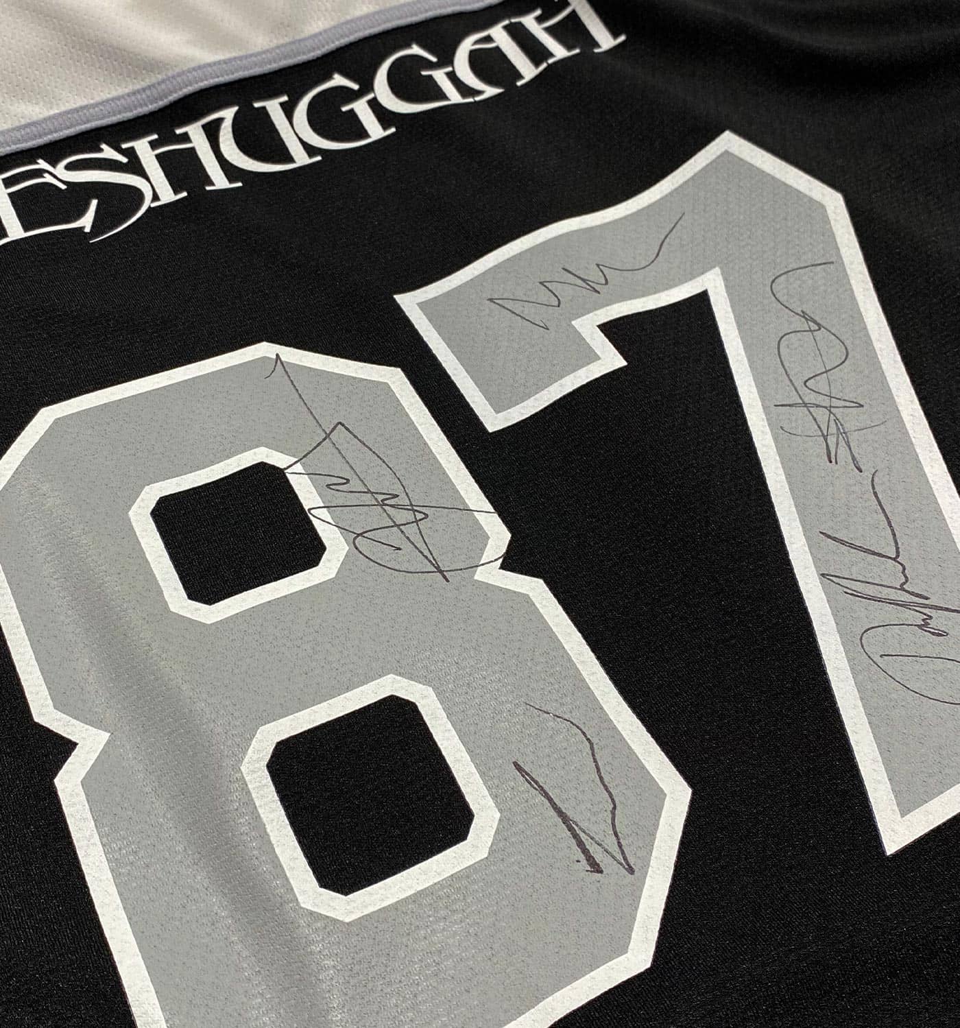 MESHUGGAH 'THIS SPITEFUL SKATE' limited edition autographed hockey jersey in black, white back view, and grey