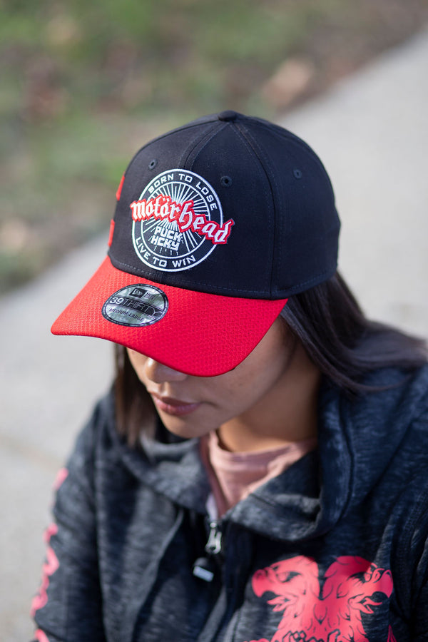 MOTÖRHEAD 'OFFICIAL PUCK' stretch fit hockey cap in black with red brim and stripes on model