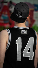 PUCK HCKY 'DETROIT' sleeveless summer league jersey in black, grey, and white back view on model