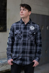 PUCK HCKY 'SHOOT PUCKS NOT PEOPLE - THE BIG SKATE' hockey flannel in grey and black plaid on model front view